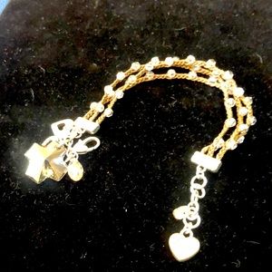 Brighton multi strand, brown cord with clear beads sewn in . Cross pendant